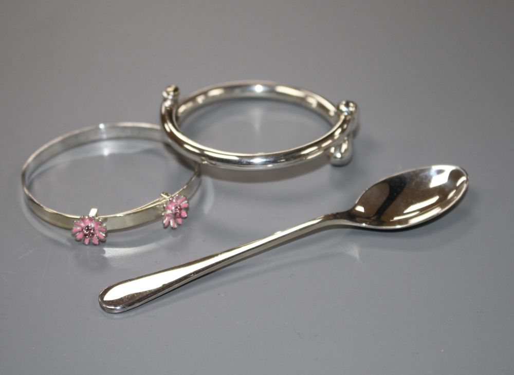 A modern silver coffee spoon and two 925 childs bangles, gross weight 31 grams.